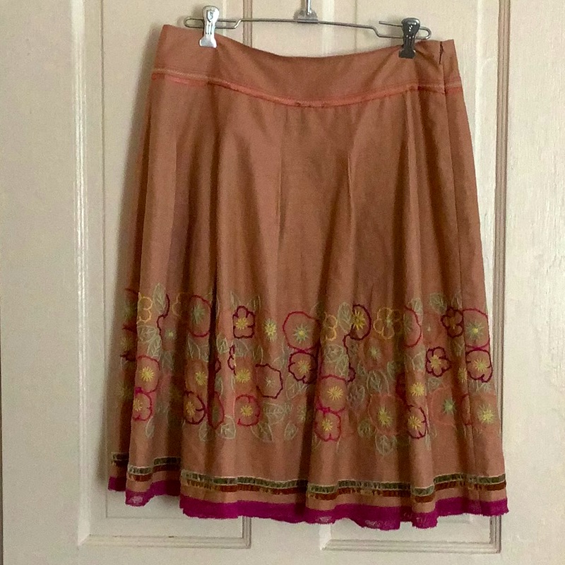 Pleated Skirt With Floral Details.